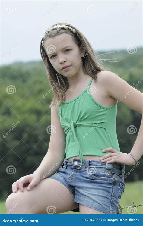 naked little teenagers|An adolescent girl, posing naked leaning on a small table, in a.